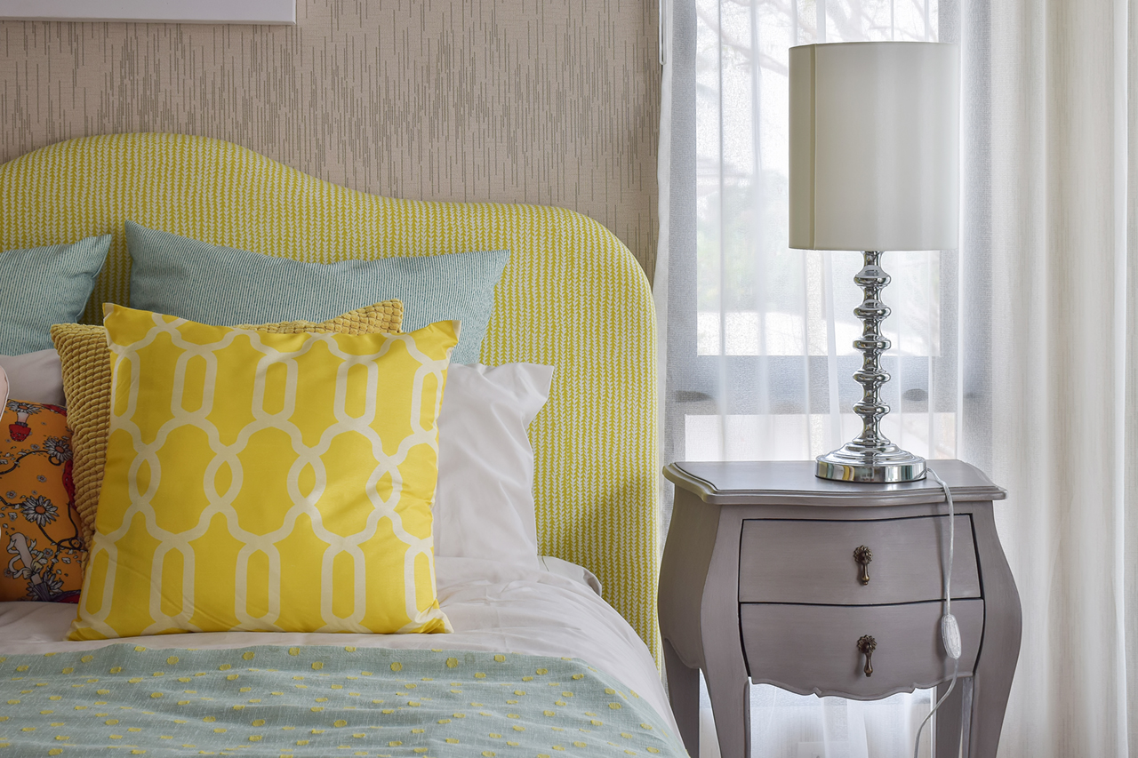 pattern pillows on classic style bed and reading lamp